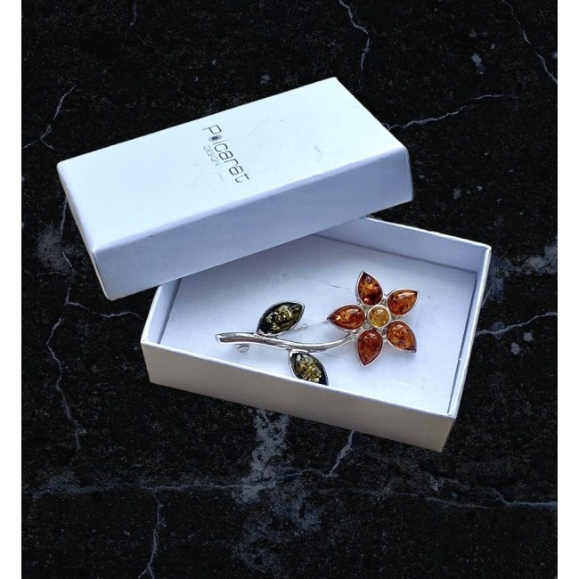 Silver flower brooch with amber