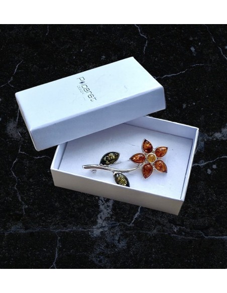 Silver flower brooch with amber