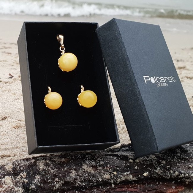 Gold-plated pendant with spherical amber, a luxurious trinket at an affordable price from the manufacturer