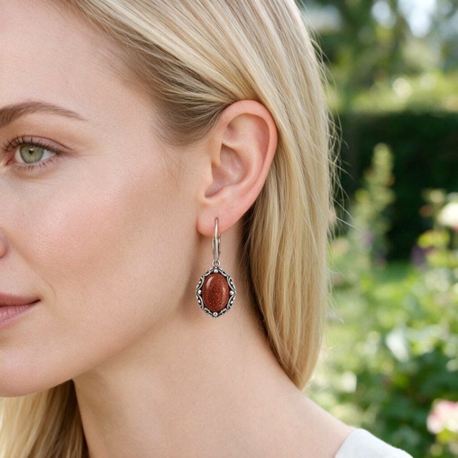 Oxidized sterling silver drop earrings with goldstone K 2169